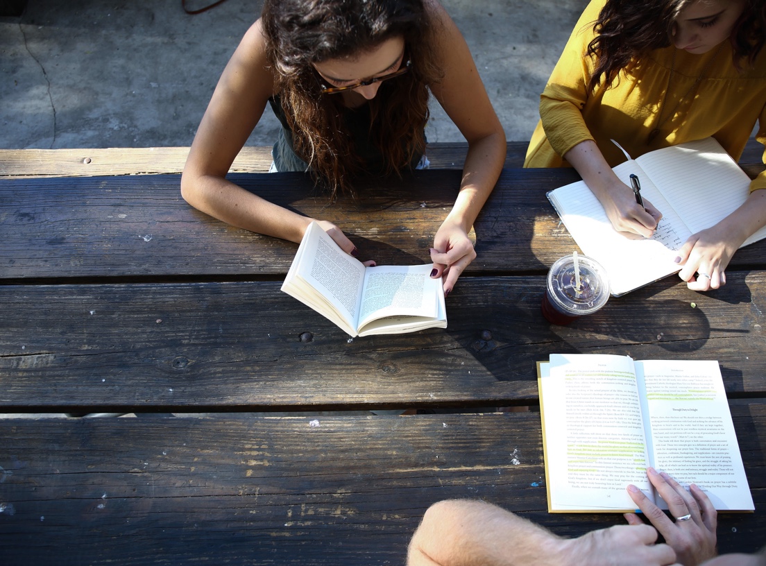 Students reading books and making notes.